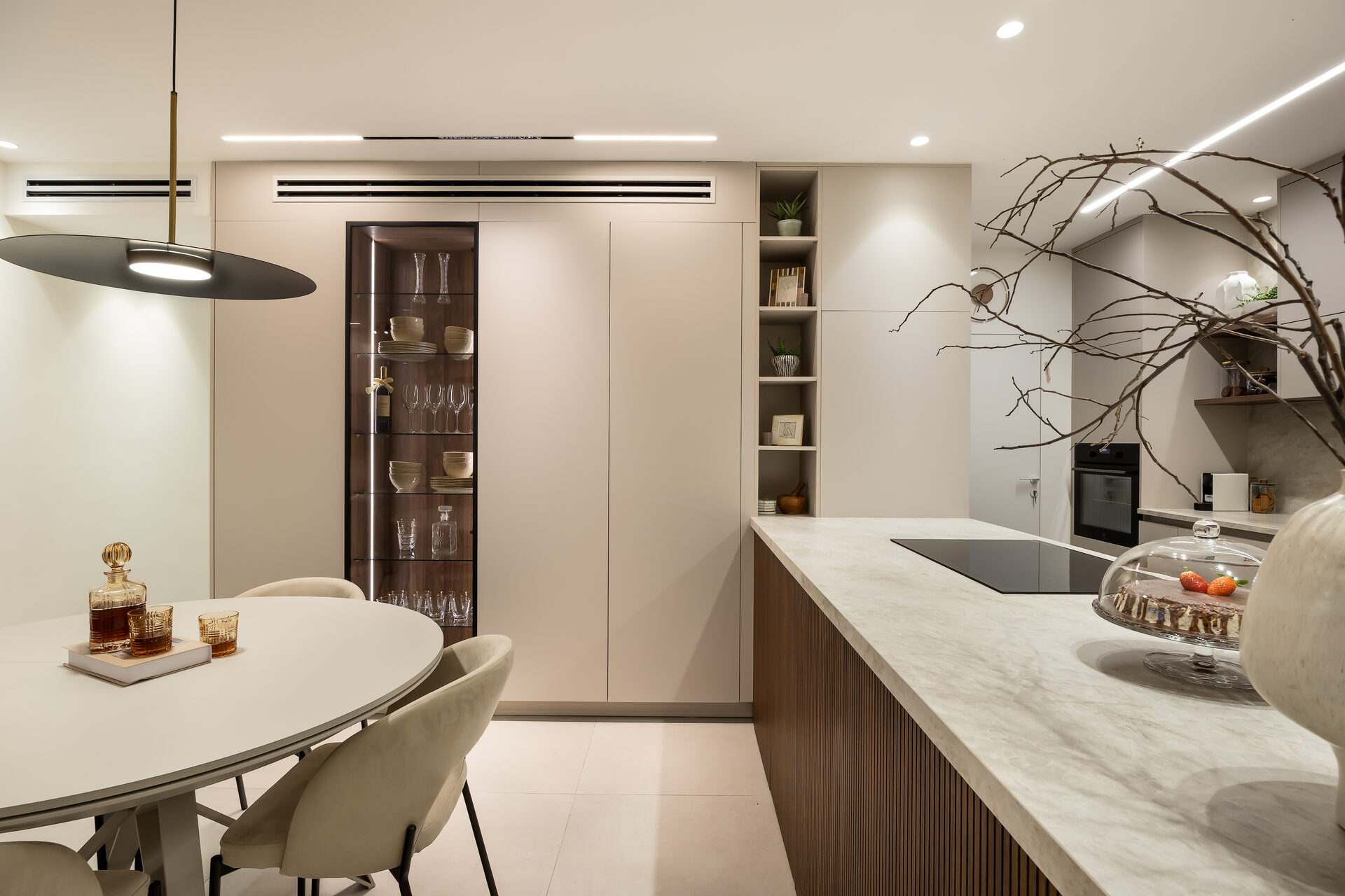 Penthouse kitchen and dining room designed by TwoDesign - warm walnut cabinetry, marble island, and elegant lighting